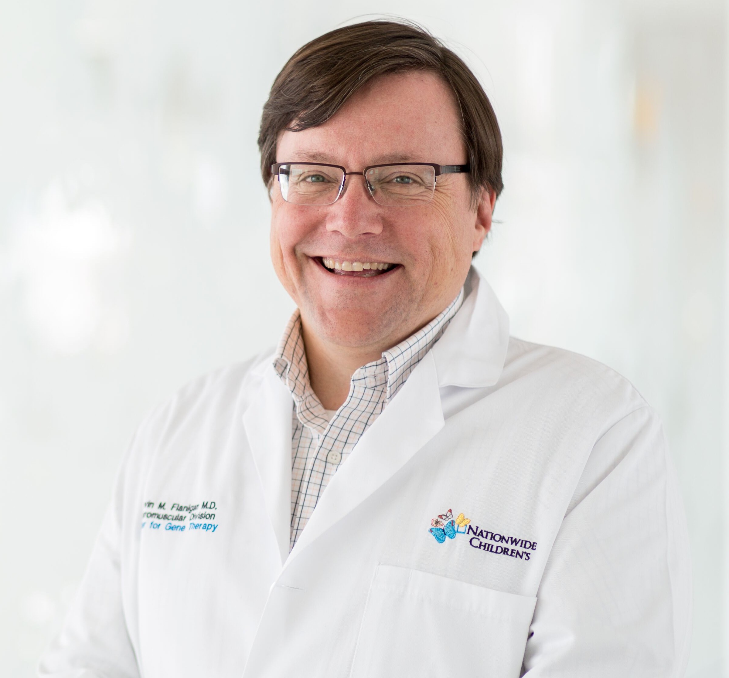 Portrait of Dr. Kevin Flanigan in a white lab coat