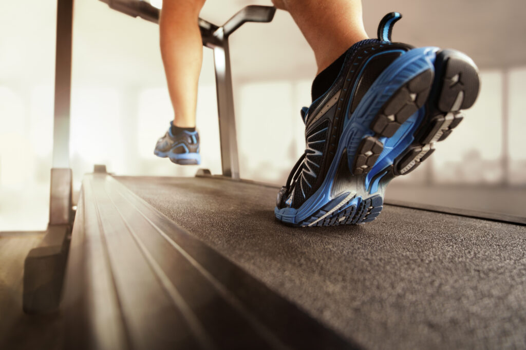 close up of tennis shoes of a young boy walking on a treadmill
