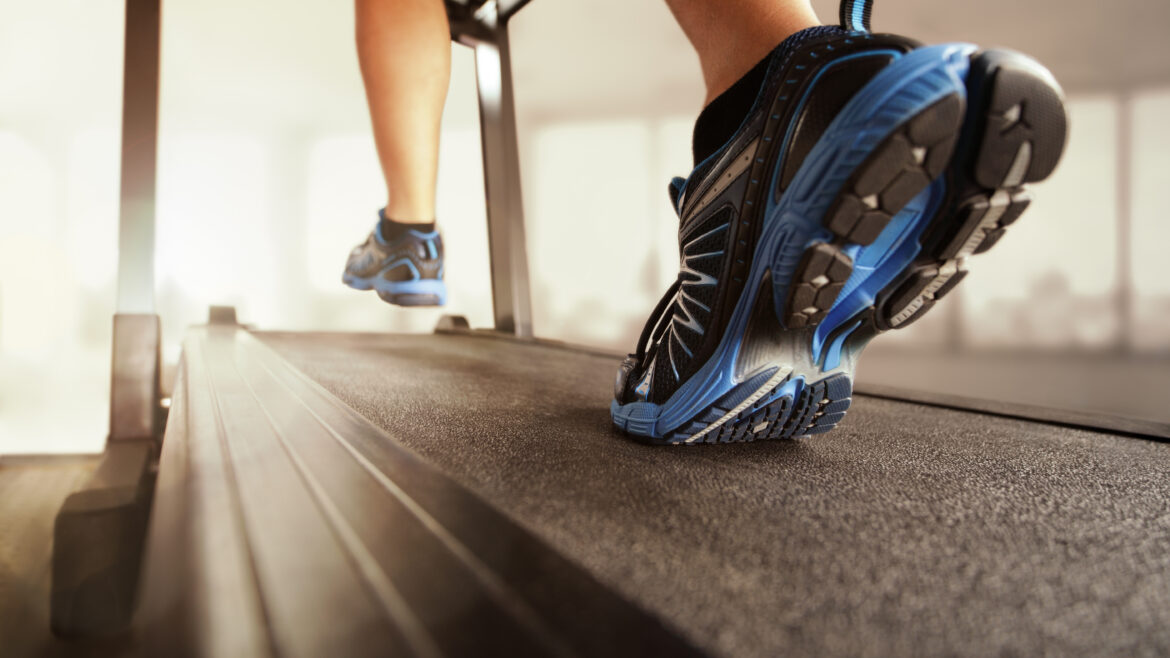 close up of tennis shoes of a young boy walking on a treadmill