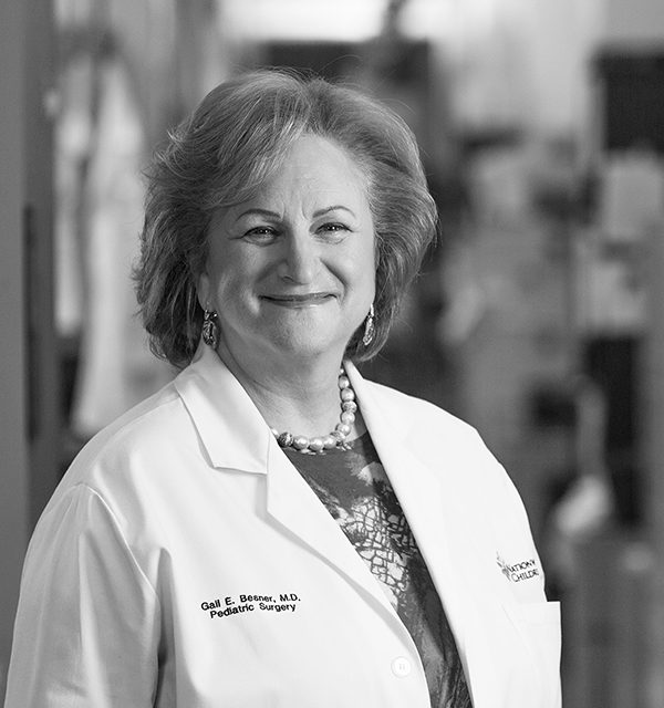 B&W image of Dr. Gail Besner posing for a photo in her lab coat