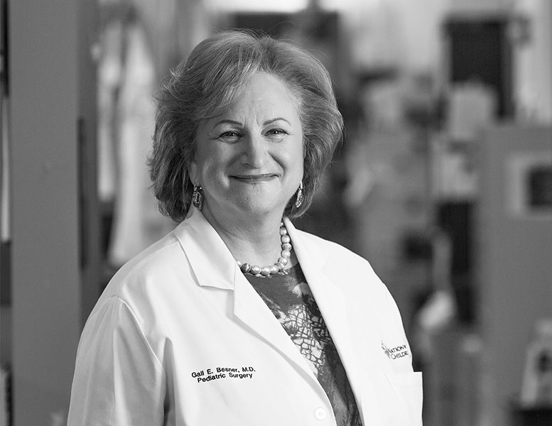 B&W image of Dr. Gail Besner posing for a photo in her lab coat