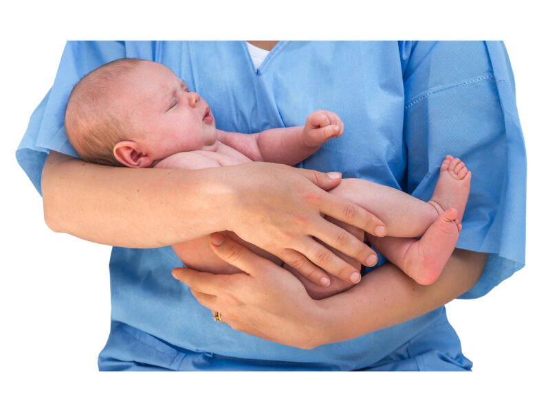 person in scrubs holding a baby
