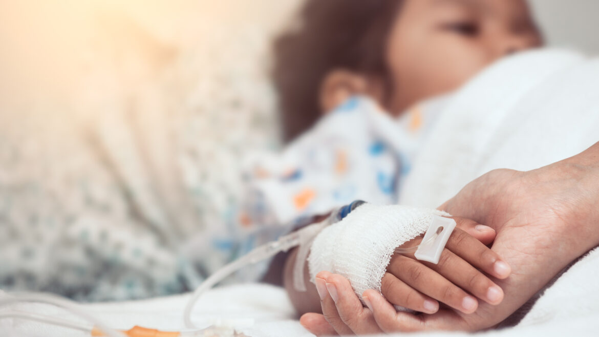 Mother hand holding child hand who have IV solution in the hospital