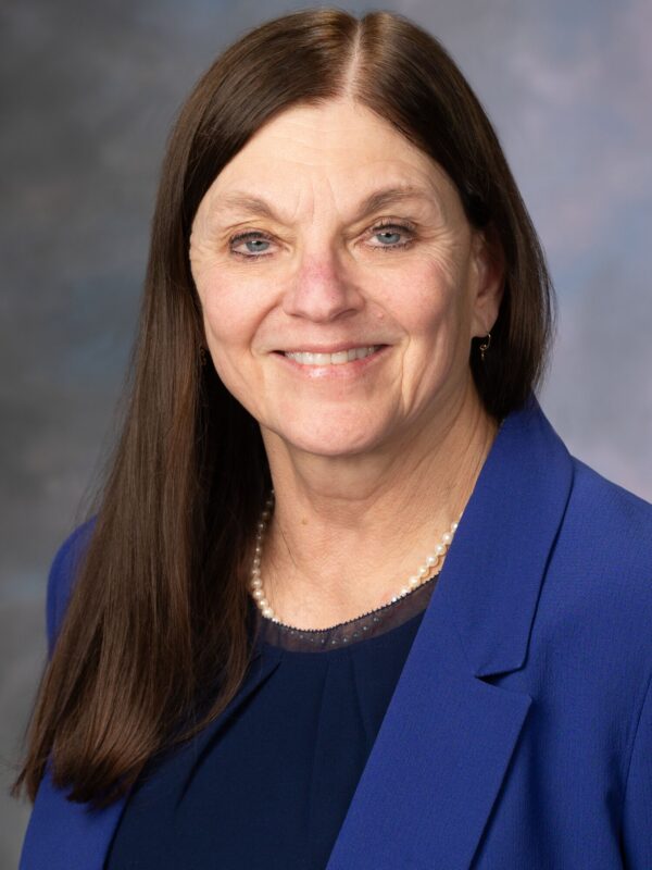 Studio portrait of Karen McCoy, MD, wearing a blue blazer