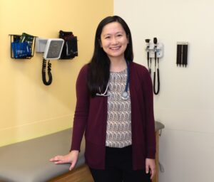 Photograph of Dr. Nina Mann, Pediatric Nephrologist at Nationwide Children's Hospital, standing in a patient room smiling at the camera.