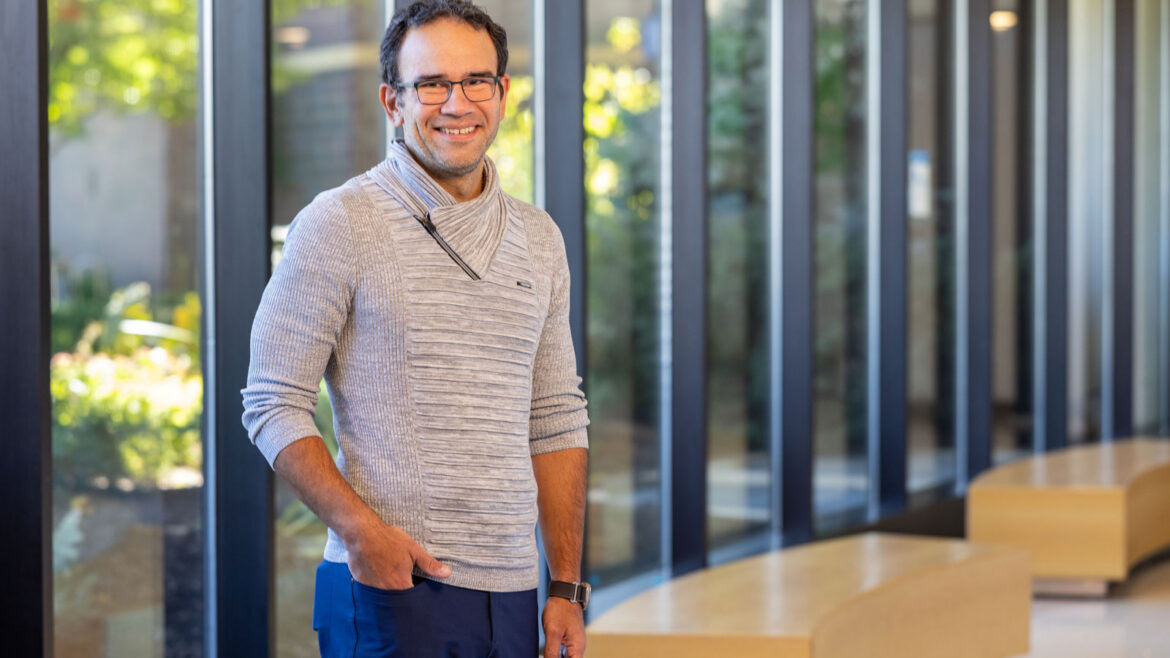 Dr. DaJusta, urologist, standing in a hospital hallway smiling.